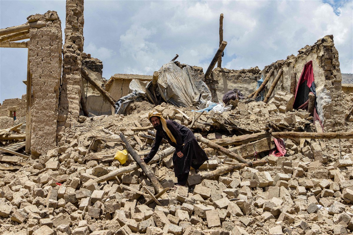 <i>Ahmad Sahel Arman/AFP/Getty Images</i><br/>An Afghan man looks for his belongings amid the ruins of a house damaged by an earthquake.