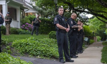 Police officers stand outside the home of U.S. Supreme Court Justice Brett Kavanaugh in anticipation of an abortion-rights demonstration on May 18 in Chevy Chase