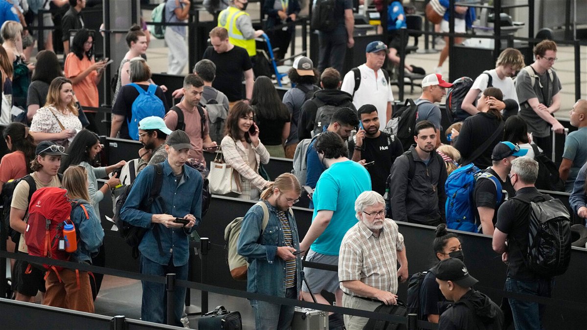 <i>David Zalubowski/AP</i><br/>Travelers maneuver through a long line this month at a security checkpoint at Denver International Airport.