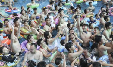 People cool off in a pool at a water park in Huaian