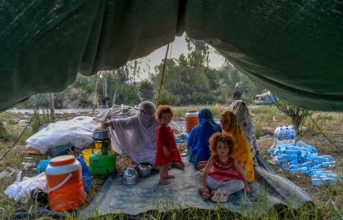 Displaced people prepare for breakfast in their tents at a makeshift camp after fleeing from their flood-hit homes following heavy monsoon rains in Charsadda district of Khyber Pakhtunkhwa on August 29.