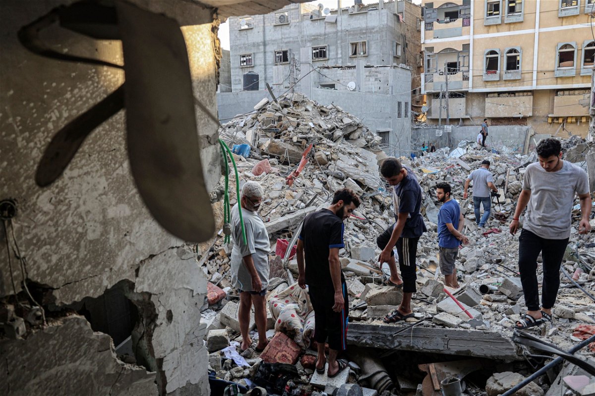 <i>Said Khatib/AFP/Getty Images</i><br/>People search through the rubble following Israeli airstrikes in Rafah on Sunday.