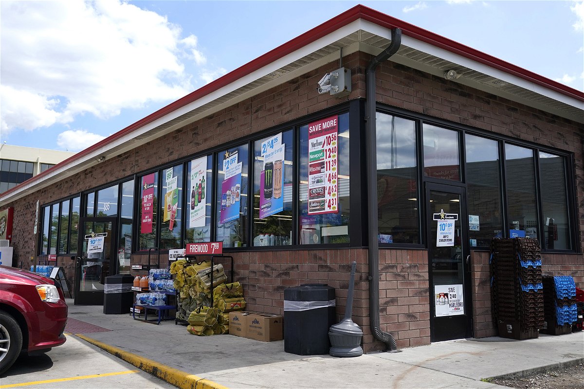 Vehicles are parked outside the Illinois Speedway gas station in Des Plaines, Ill., where the winning Mega Millions lottery ticket was sold, Saturday, July 30, 2022. A ticket-holder in the state clinched the $1.337 billion Mega Millions jackpot from the ticket was sold there. (AP Photo/Nam Y. Huh)