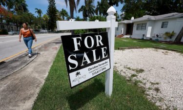 Home sales declined for the sixth month in a row in July as higher mortgage rates and prices push prospective buyers out of the market. A 'for sale' sign hangs in front of a home on June 21 in Miami.