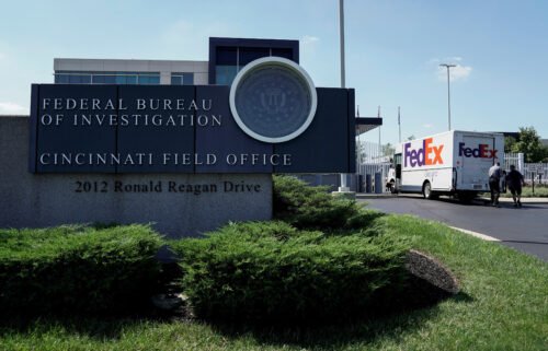 A FedEx truck is inspected outside of the front gate of the FBI's Cincinnati Field Office on August 11. The FBI is investigating an "unprecedented" number of threats against bureau personnel and property.