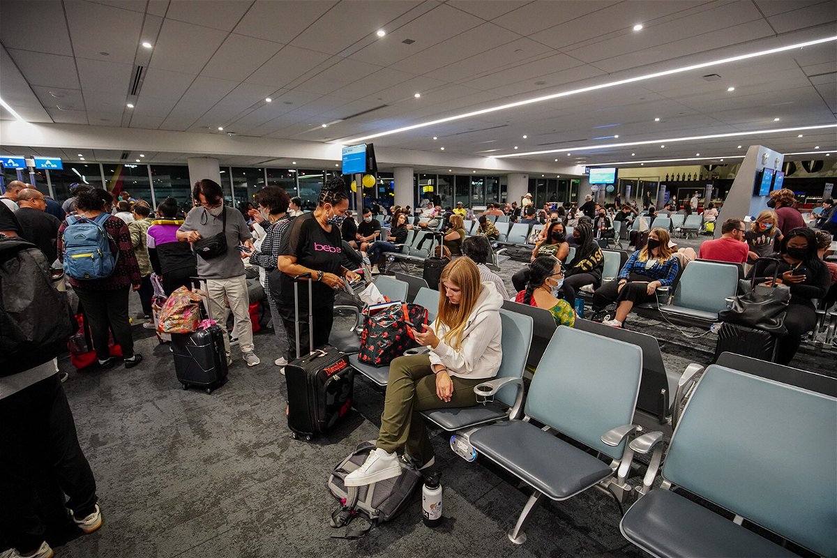 <i>Michael Ho Wai Lee/SOPA Images/Sipa</i><br/>Travelers wait for their flight at Los Angeles International Airport. After two years of the pandemic