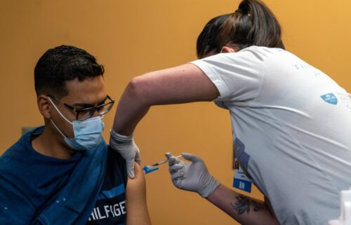 A healthcare worker administers a dose of the Pfizer-BioNTech Covid-19 vaccine in Peabody