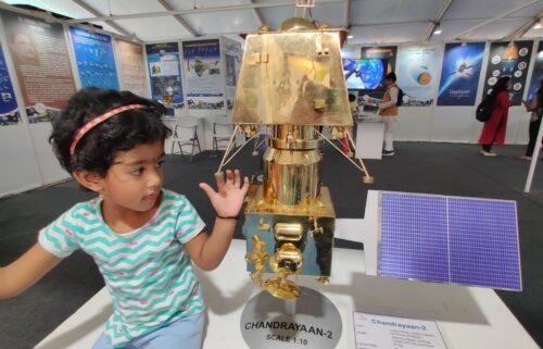 A child touches a model of Indian mission to the moon.