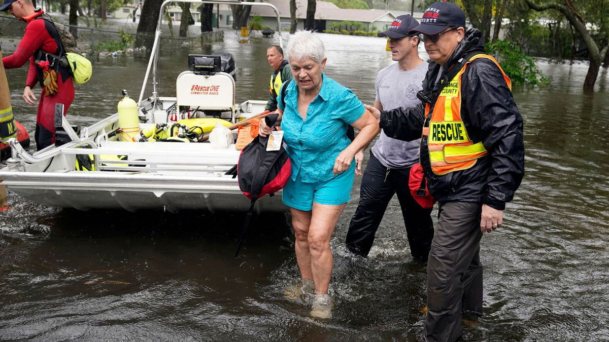 A resident in an Orlando, Florida, neighborhood is rescued from floodwaters in the aftermath of Hurricane Ian on September 29.
