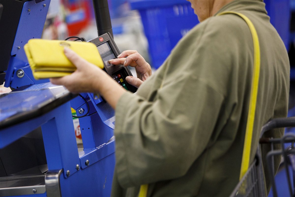 <i>Patrick T. Fallon/Bloomberg/Getty Images</i><br/>A customer uses a credit card terminal to complete a purchase at a Wal-Mart Stores Inc. location in Burbank