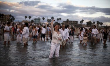 Rabbi Naomi Levy throws bread crumbs into the Pacific Ocean at the Nashuva Spiritual Community Jewish New Year celebration on Venice Beach in Los Angeles in 2015.