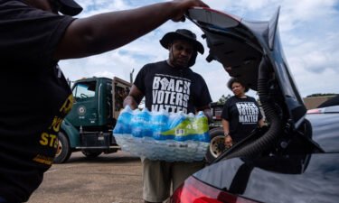 Residents distribute cases of water at a community center in Jackson this month.
