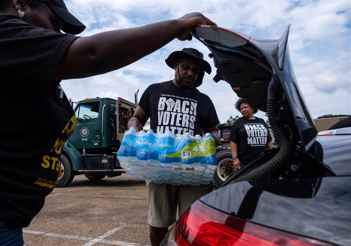 <i>Seth Herald/AFP/Getty Images</i><br/>Residents distribute cases of water at a community center in Jackson this month.