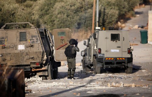 Palestinian youths and Israeli forces clash as troops surround a building in the village of Deir al-Hatab. A Palestinian man was killed and two journalists shot and injured by Israeli forces during an Israeli military raid on October 5.