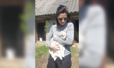 CNN's Erin Burnett holds a newborn goat in the Ukrainian town of Andriivka on May 11.