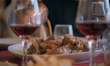 Chef Pino Trimbol pours the juices from the lamb over the home-style Calabrian dish.