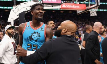 Deandre Ayton of the Phoenix Suns is restrained after being pushed to the court on November 22.
