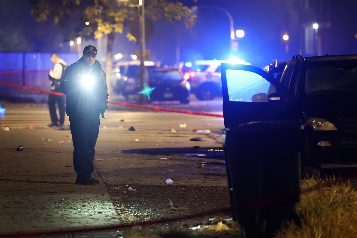 <i>Scott Olson/Getty Images</i><br/>Police investigate at the scene of a drive-by shooting in Chicago Monday night.