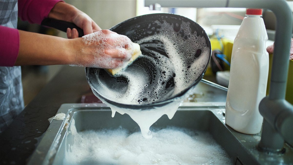 <i>gilaxia/E+/Getty Images</i><br/>Washing dishes with a limited amount of water — instead of a running tap — is one way to reduce water use at home.