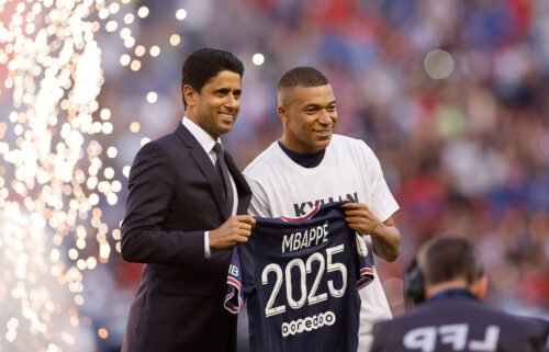 Paris St. Germain's Kylian Mbappe (right) poses for a photo with Paris St. Germain president Nasser Al-Khelaifi after signing a new contract on May 21.