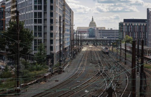 An arcane 96-year-old law stopped the rail strike. The U.S. Capitol is seen beyond commuter and freight railway tracks in Washington