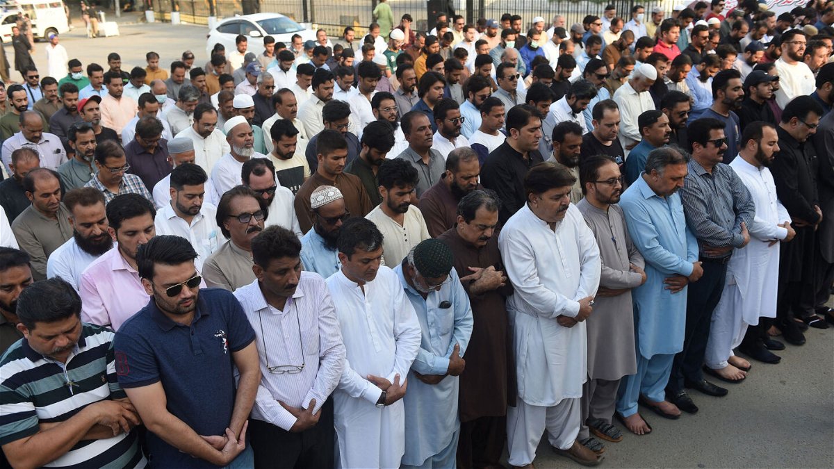<i>Rizwan Tabassum/AFP/Getty Images</i><br/>Mourners offer absentia funeral prayers in Karachi on October 27 for Sharif.
