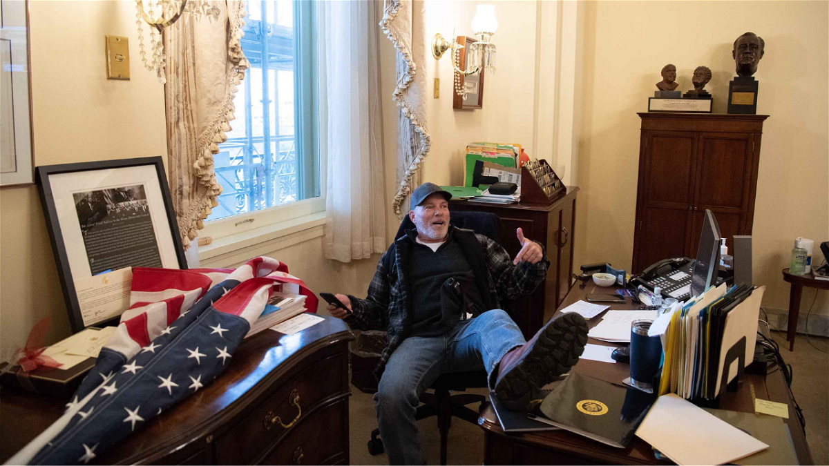 Richard Barnett was found guilty on eight counts by a Washington, DC, jury on Monday. Trump supporter Barnett is pictured here inside Nancy Pelosi's office at the US Capitol in Washington, DC, January 6, 2021.