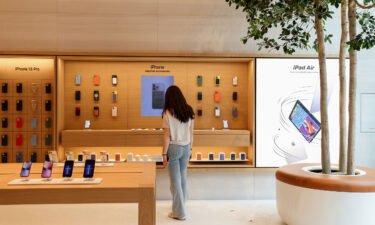 Apple has lost $1 trillion in market value in a year. A visitor browses an iPhone display at a new Apple store.