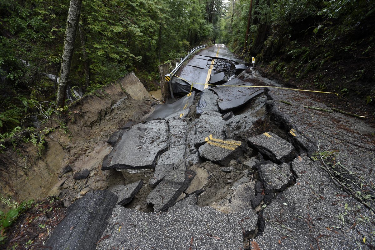 <i>Neal Waters/Anadolu Agency/Getty Images</i><br/>A view of damage on the road after heavy rain in the Santa Cruz Mountains above Silicon Valley in California Monday.