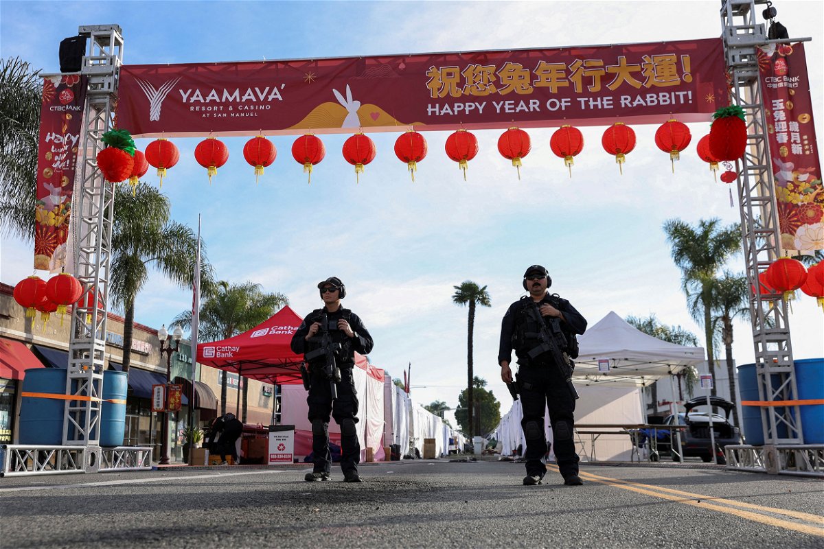 <i>Mike Blake/Reuters</i><br/>Police officers guard the area near the location of a shooting that took place in Monterey Park.