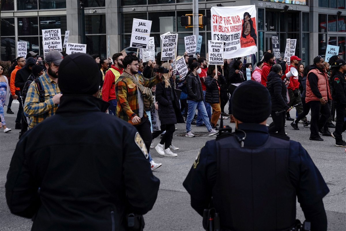 <i>Cheney Orr/AFP/Getty Images</i><br/>Atlanta police officers watch as protesters march during a rally against the fatal Memphis police assault of Tyre Nichols