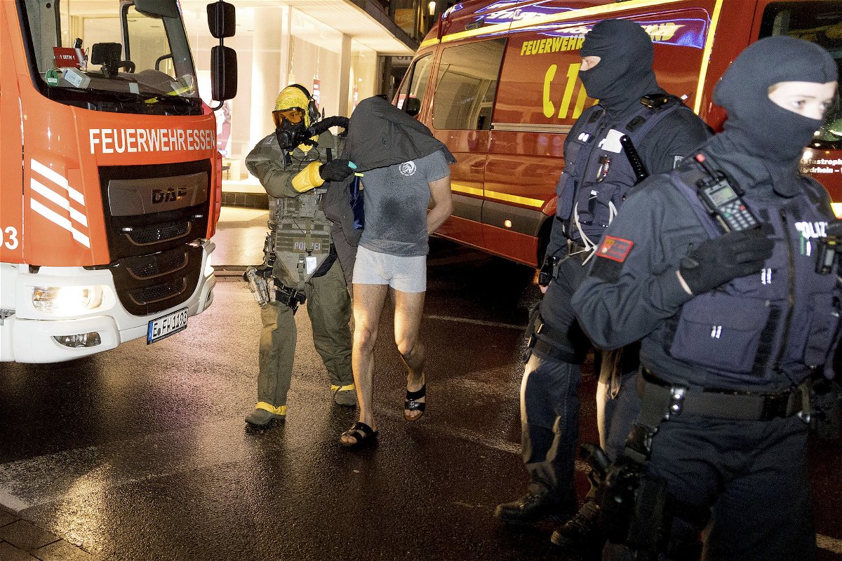 <i>Karsten Wickern/picture alliance/dpa/AP</i><br/>German police detain the suspect in Castrop-Rauxel