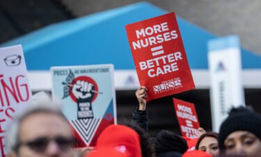 Nurses and healthcare workers hold signs during a strike at Mount Sinai Hospital in New York on January 9.