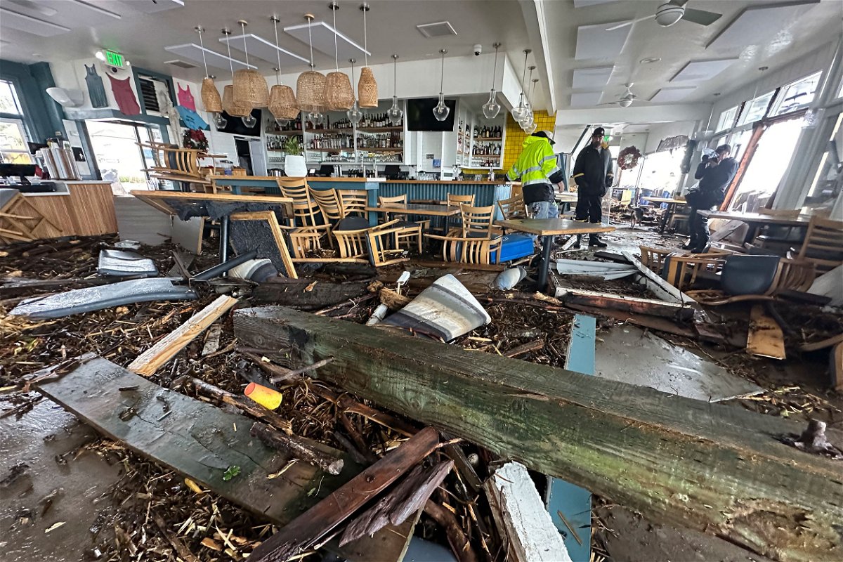 <i>Shmuel Thaler/The Santa Cruz Sentintel/AP</i><br/>A support piece from the Capitola Wharf lies in the storm-damaged Zelda's restaurant in Capitola
