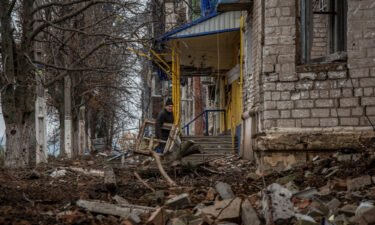 A resident walks near his house destroyed by Russian shelling
