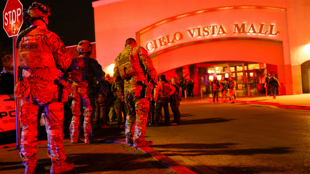 Law enforcement members gather outside the Cielo Vista Mall after a shooting, in El Paso, Texas, Wednesday.