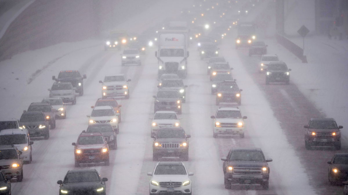 Rush hour traffic travels southbound on Interstate 35W in Minneapolis as a winter storm began hitting the Twin Cities on Tuesday.