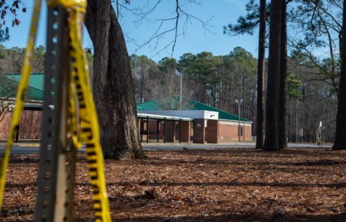 Police tape hangs from a sign post outside Richneck Elementary School following a shooting on January 7 in Newport News