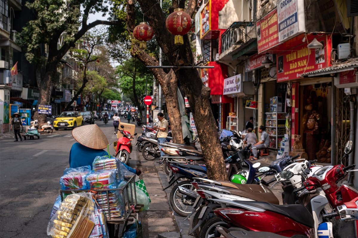 <i>Linh Pham/Bloomberg/Getty Images</i><br/>A street vendor pushes a bicycle along a road in the old quarter in Hanoi