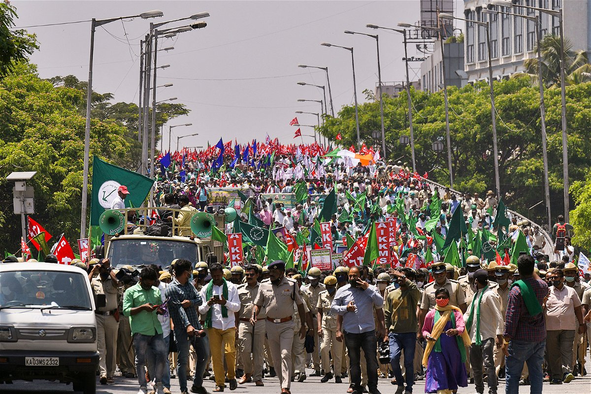 <i>Manjunath Kiran/AFP/Getty Images/File</i><br/>Police march in front of farmers during a protest against the central government's proposed agricultural reforms in Bangalore on March 22