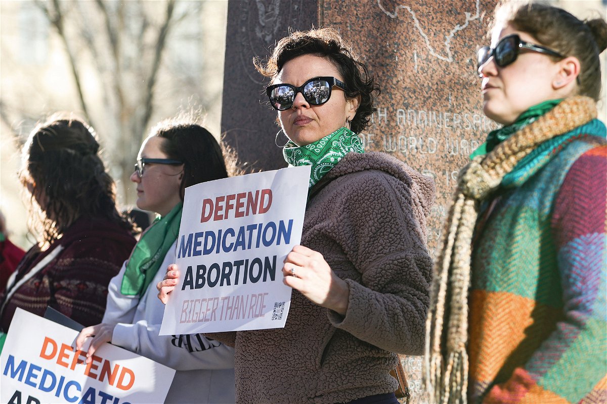 <i>David Erickson/AP</i><br/>Lindsay London holds a protest sign in support of access to abortion medication outside the Federal Courthouse on March 15 in Amarillo
