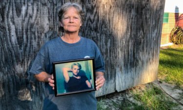 Sandy Smith holds a photo of her late son