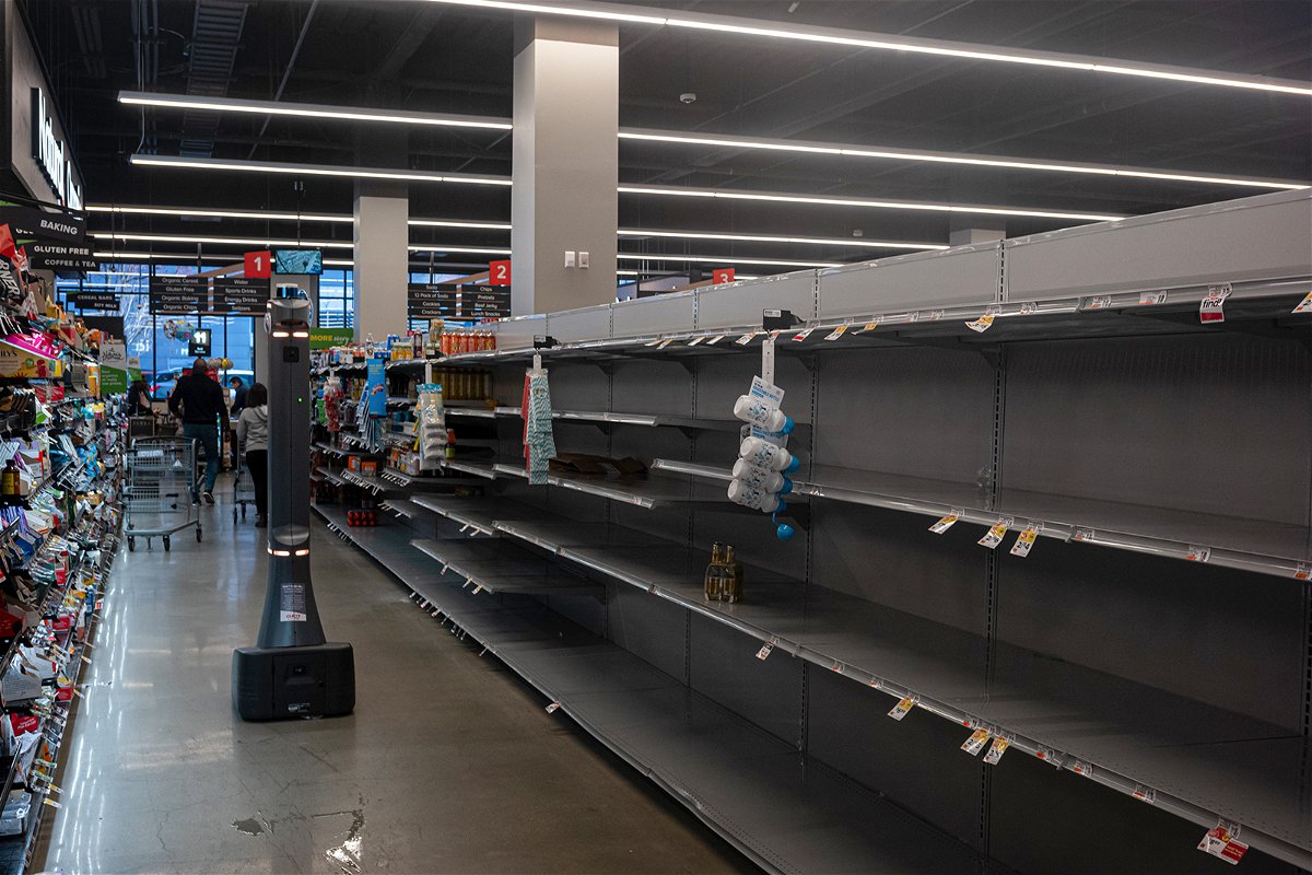<i>Thomas Hengge/Anadolu Agency/Getty Images</i><br/>A water aisle is barren at Giant Supermarket in Philadelphia on March 26.
