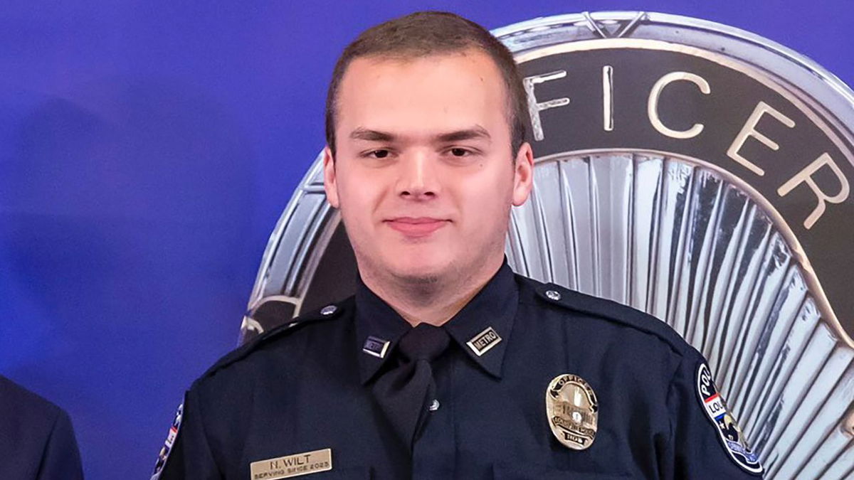 Louisville Metro Police Department Officer Nickolas Wilt, 26, was taken to the hospital and had brain surgery after he was shot in the head during a mass shooting at a bank that left four people dead and nine injured victims.
