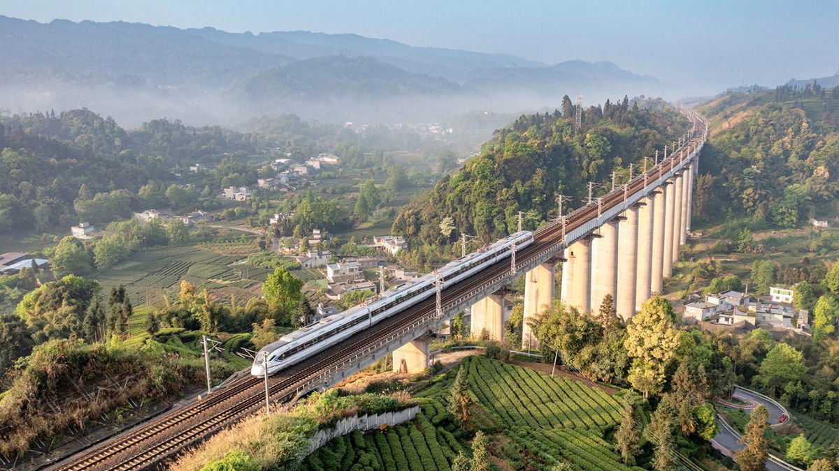 A bullet train runs through a tea garden on April 12, in Yan'an, Sichuan Province of China.
