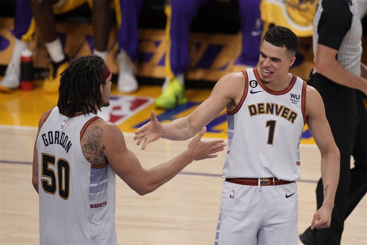 Denver Nuggets forward Michael Porter Jr. (1) shakes hands with forward Aaron Gordon in the second half of Game 4 of the NBA basketball Western Conference Final series Monday, May 22, 2023, in Los Angeles. (AP Photo/Mark J. Terrill)