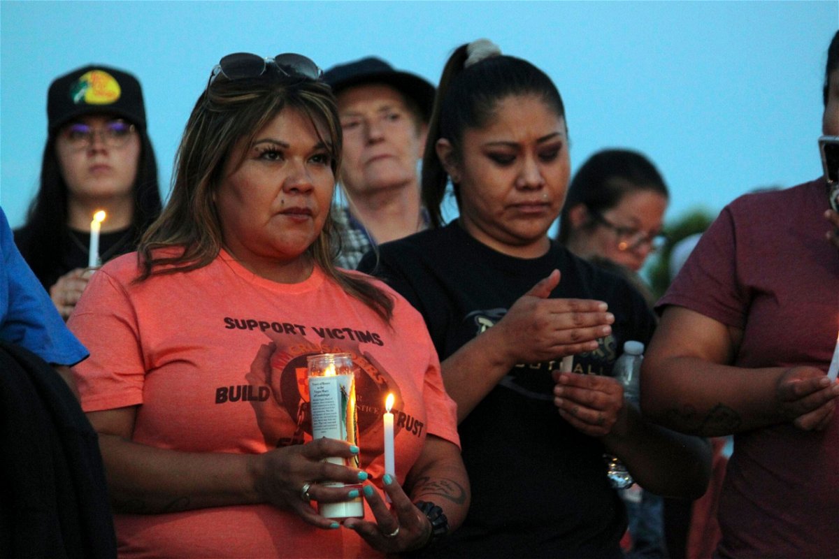 <i>Susan Montoya Bryan/AP</i><br/>Mourners hold candles Monday during a vigil in Farmington