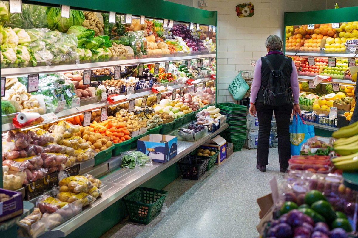 <i>Dominic Lipinski/Bloomberg/Getty Images</i><br/>A shopper browses fruit and vegetables at an indoor market in Sheffield