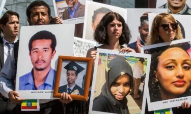 People hold signs during a vigil for victims of the Ethiopian Airlines Flight ET302 crash on September 10