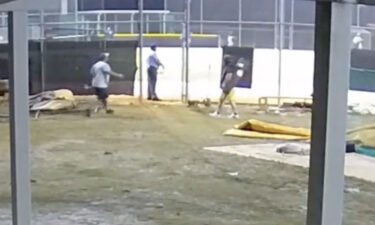 A man approaches an umpire at a Florida high school game
